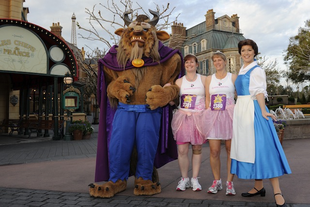 Runners pose with Belle and the Beast